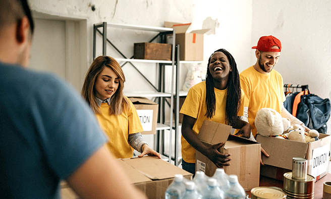 group of volunteers packing donation boxes